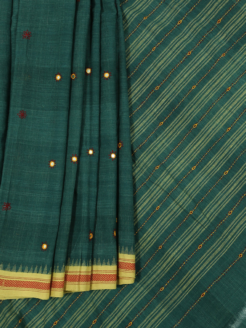 Khadi cotton natural dye in a blue shade with cream dabbi border and mirror work on the body